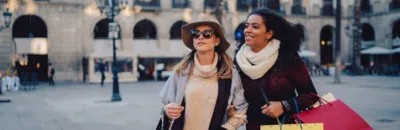 Two woman walking together with shopping bags